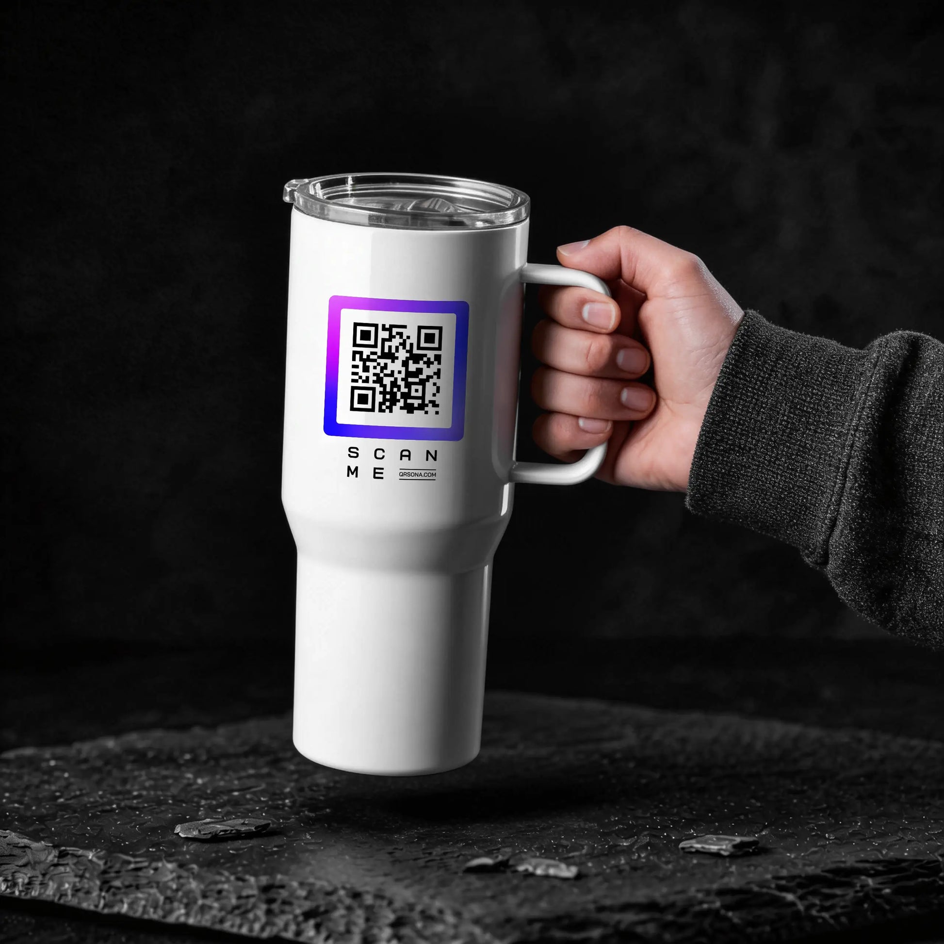 Hand holding glossy white travel mug with purple qr code on the dark background